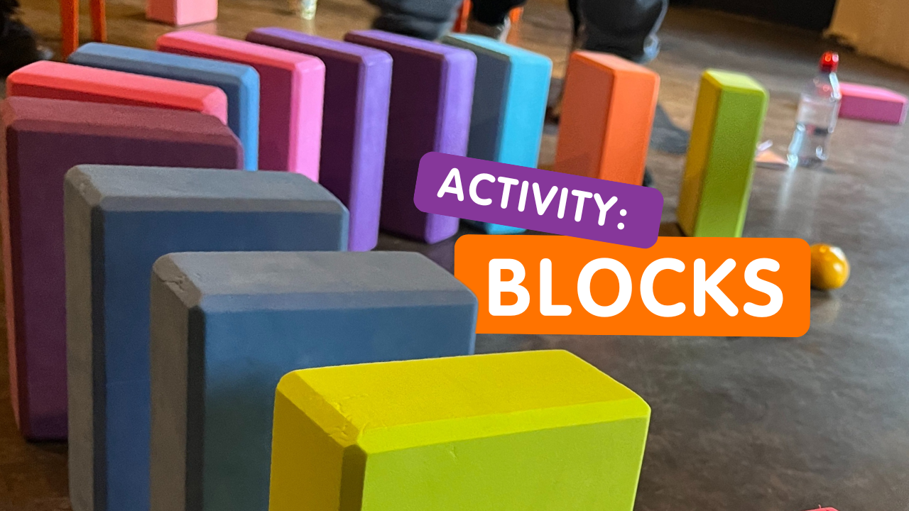 brightly coloured yoga blocks are lined up along the floor. words read: activity blocks