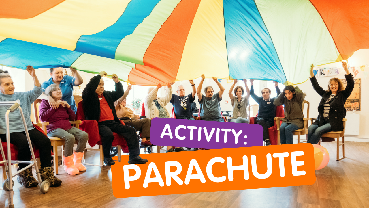 A group of older people and care home staff sit together and wave a parachute above their heads smiling. words read: acivity, parachute